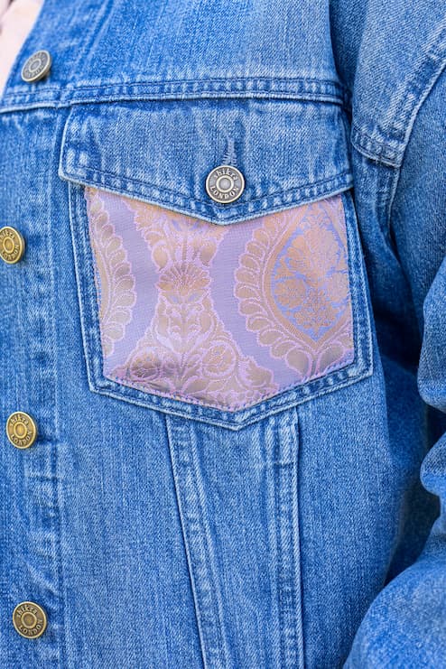 Outside pocket of Indo-western denim jacket with vegan silk saree panels in purple