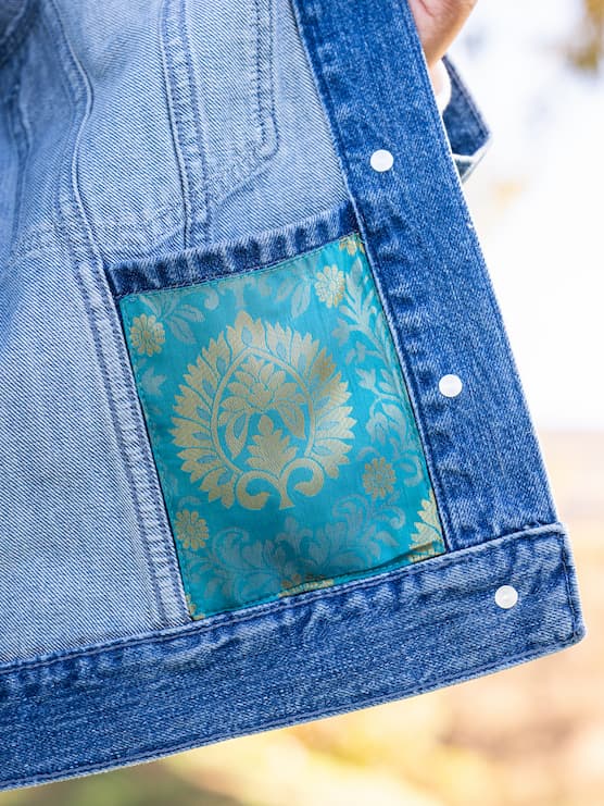 Inside pocket of Indo-western denim jacket with vegan silk saree panels in blue